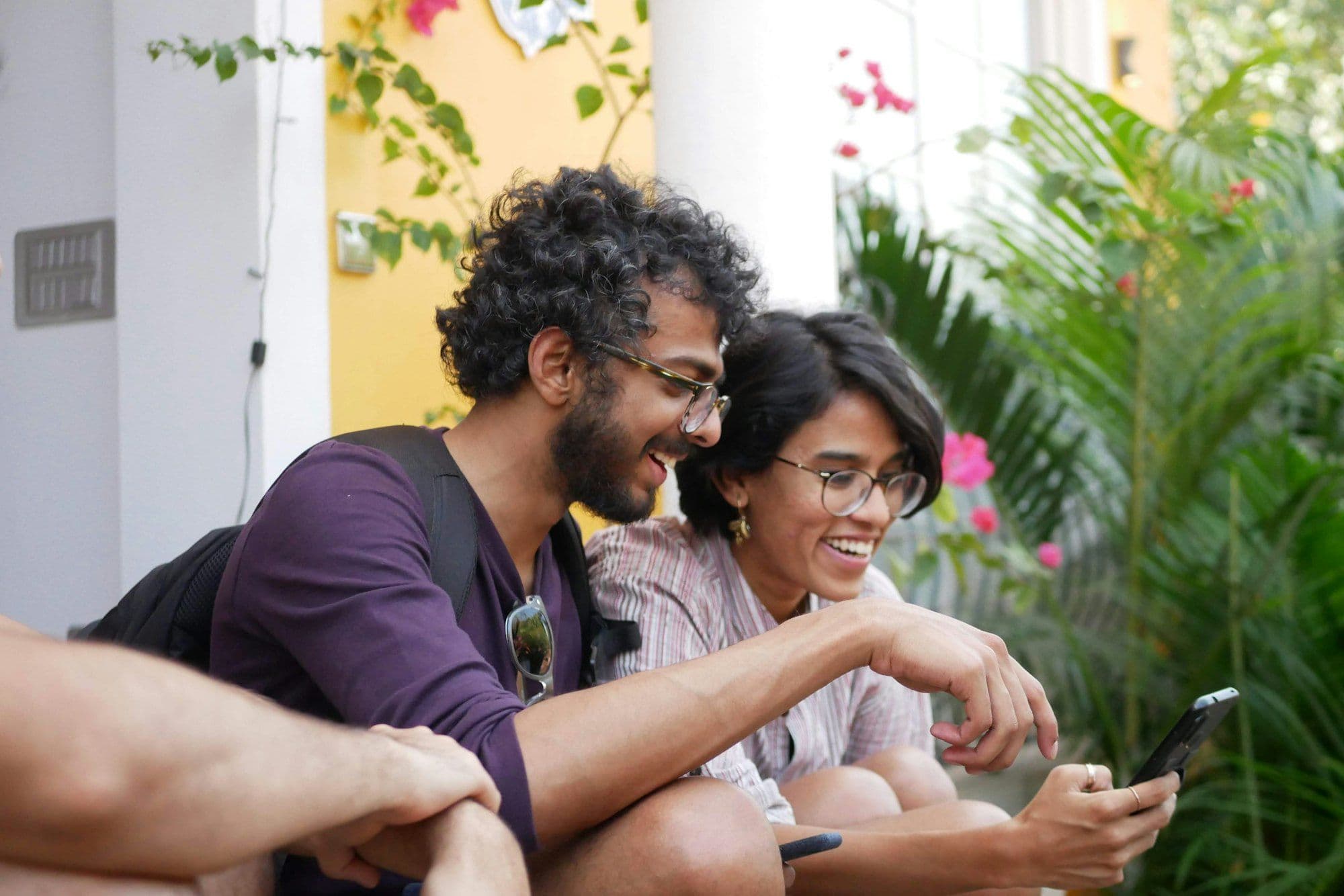 Two friends looking at a phone together